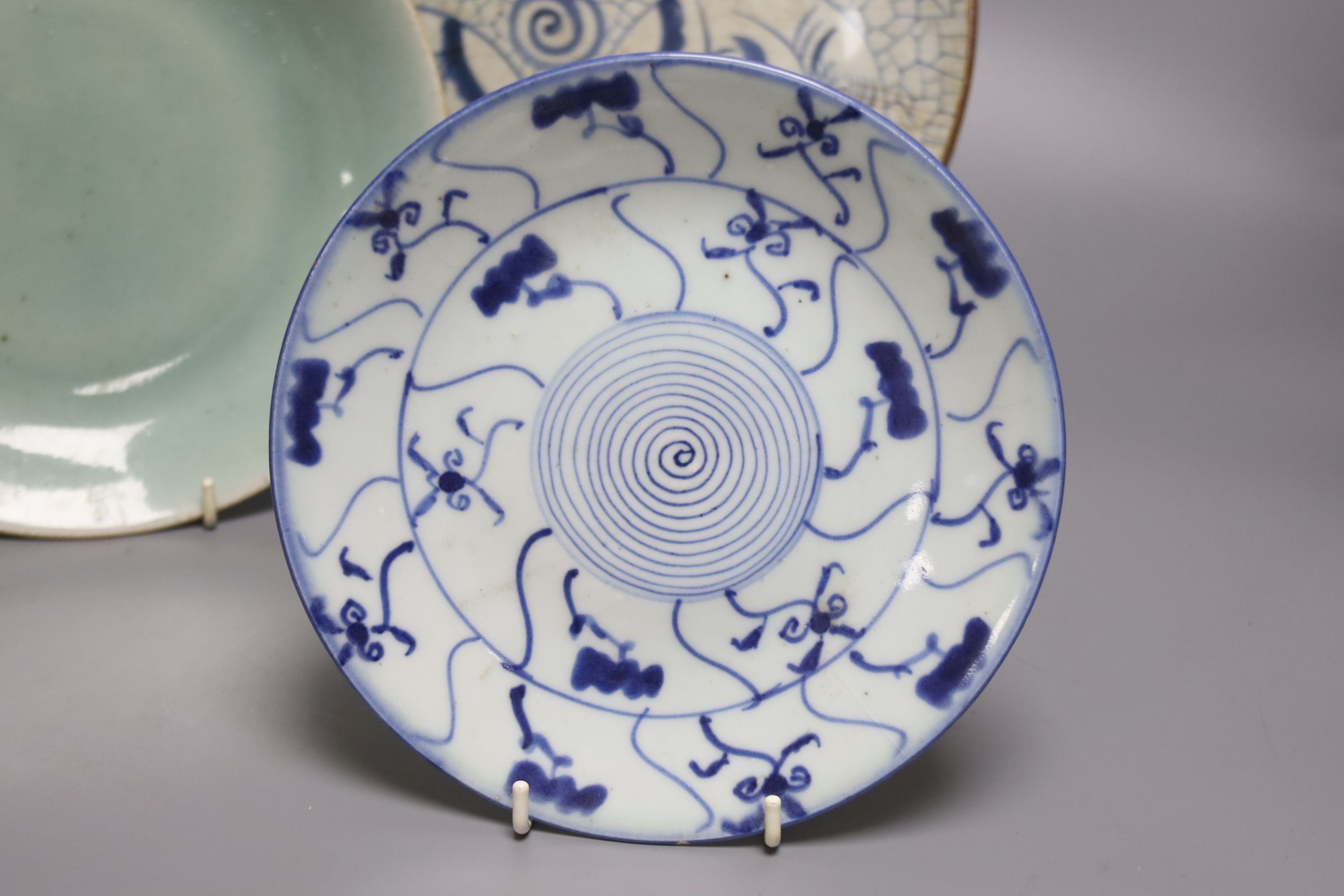 A Japanese crackle glazed dish, another similar and a Chinese celadon glazed dish, largest diameter 29.5cm